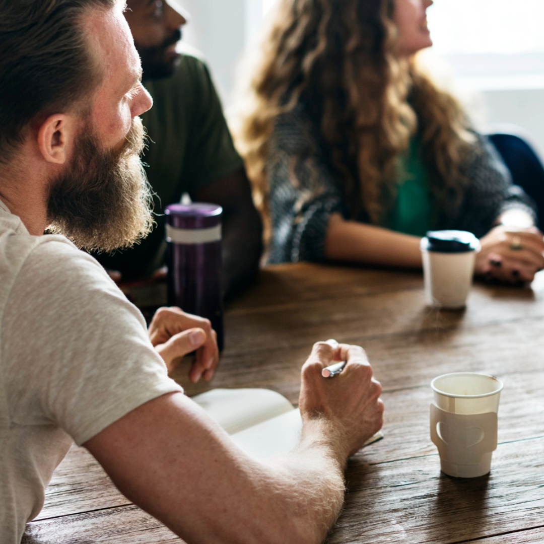 People in meeting round a table talking
