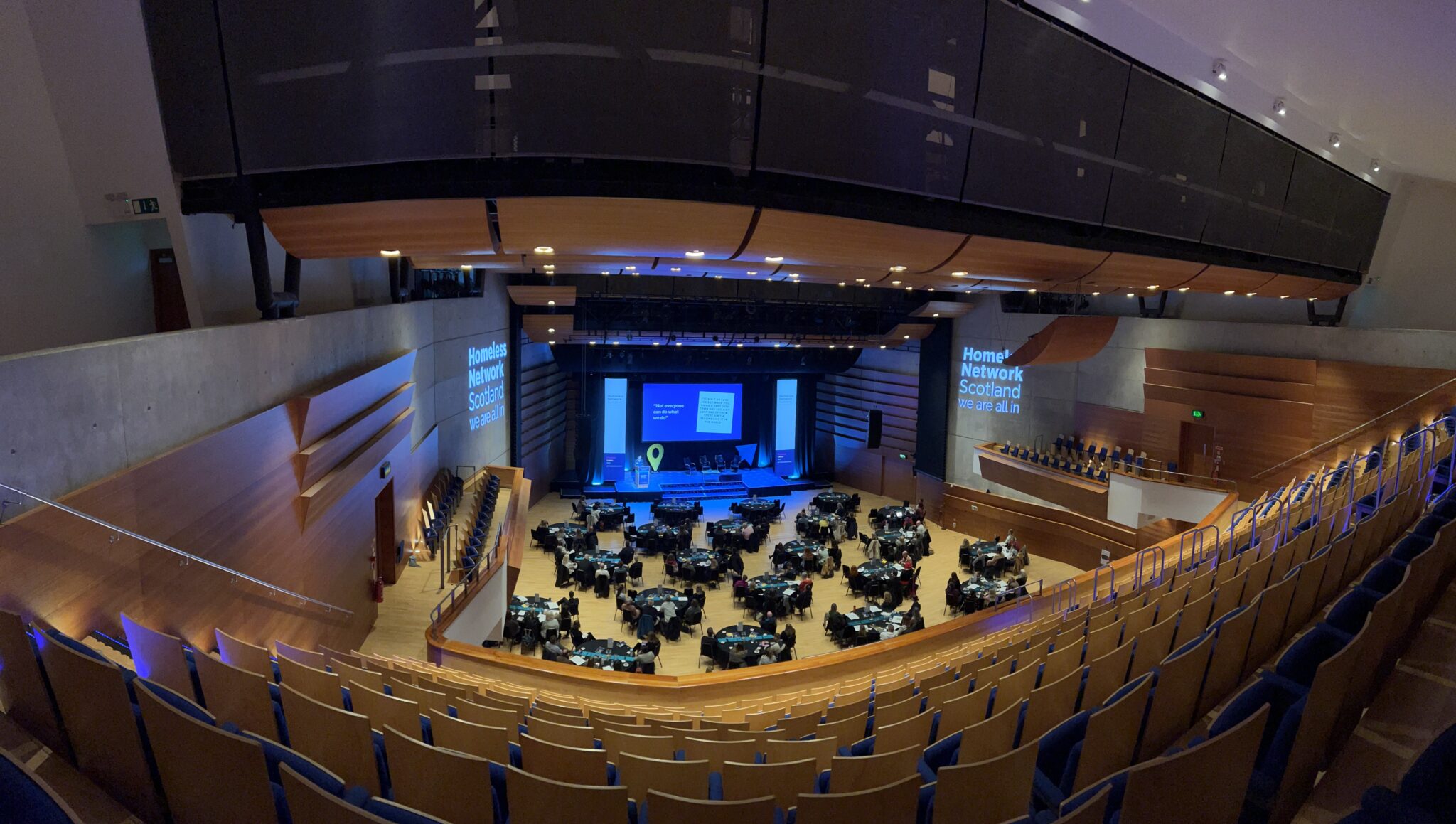 a large auditorium with chairs and tables